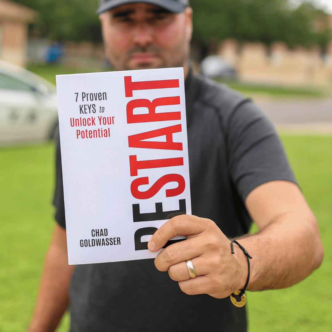 man holding a book called Restart